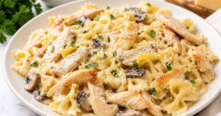 Creamy garlic chicken pasta with parmesan cheese and tender chicken in rich garlic cream sauce